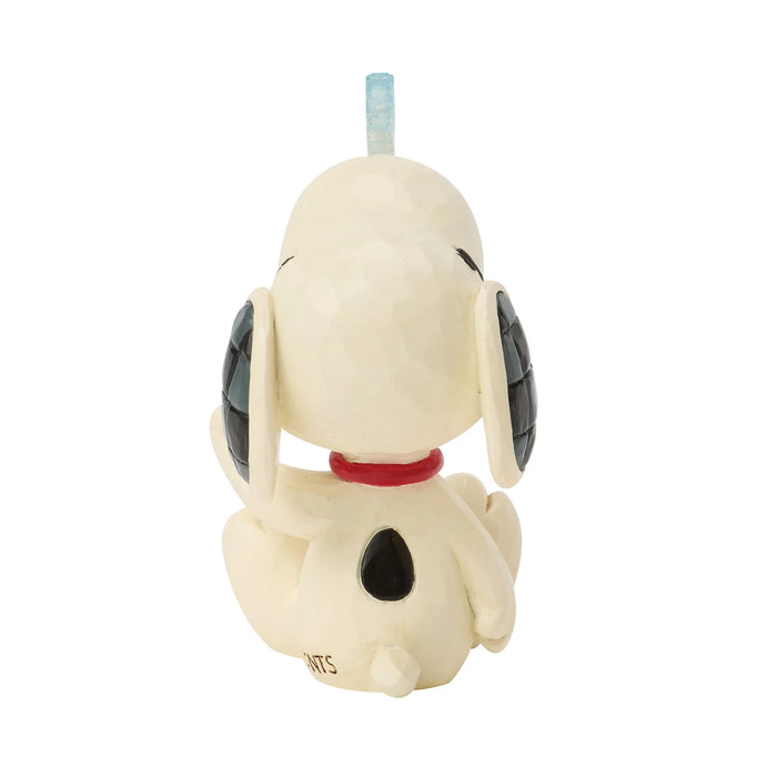 Figurine of a dog with a red collar on a white background
