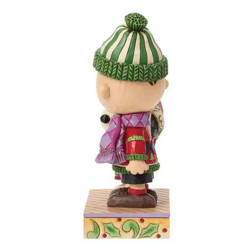 Figurine of a character wearing a green and white striped hat and colorful outfit on a white background