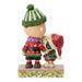 Two figurines wearing festive clothing on a decorative base with a white background