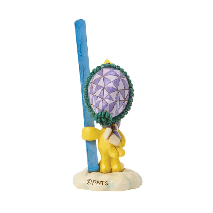 Figurine of a character holding a blue ski poles with a purple and green top on a white background