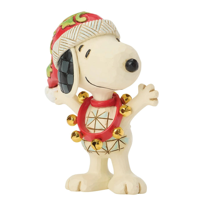 Snoopy figurine wearing a festive hat and scarf on a white background
