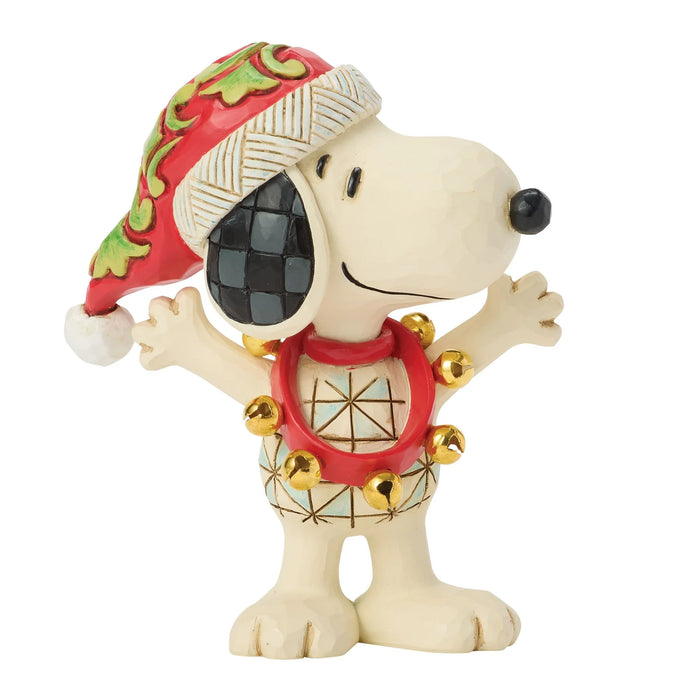 Snoopy figurine wearing a festive hat and outfit on a white background