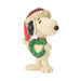 Snoopy figurine holding a heart-shaped wreath in a Santa hat