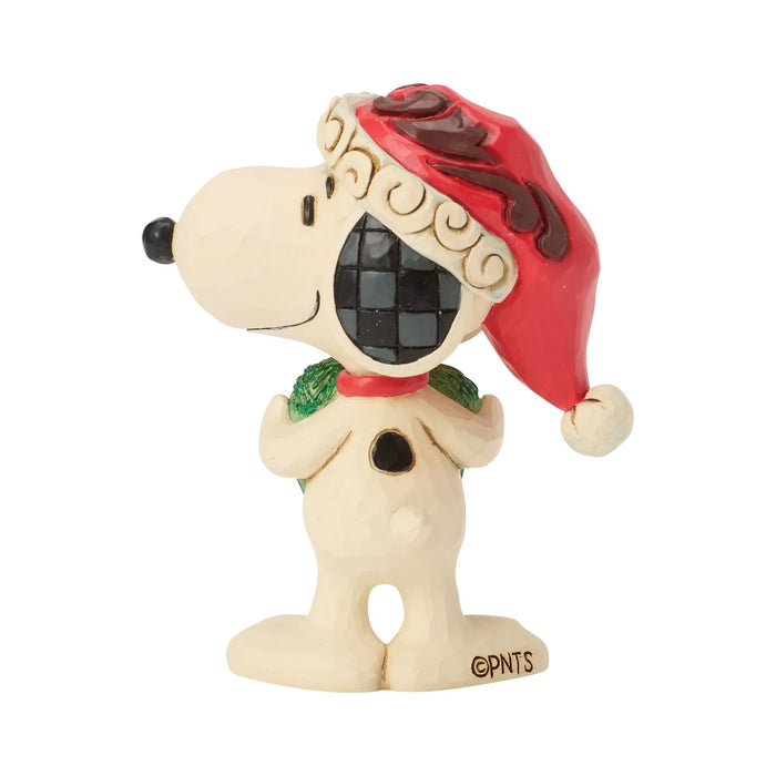 Snoopy figurine holding a heart-shaped wreath in a Santa hat