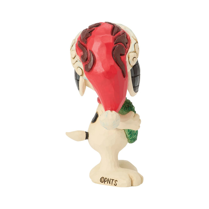 Snoopy figurine holding a heart-shaped wreath in a Santa hat