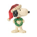 Snoopy figurine holding a heart-shaped wreath in a Santa hat