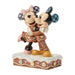 Statue of Mickey and Minnie Mouse embracing on a decorative base with a white background
