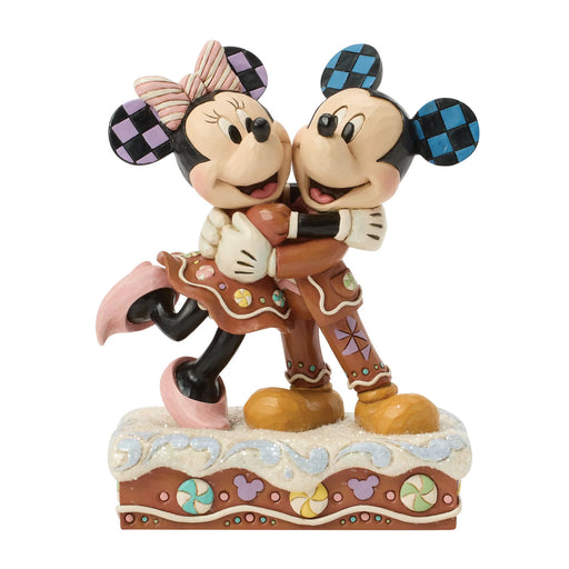 Statue of Mickey and Minnie Mouse hugging on a white background