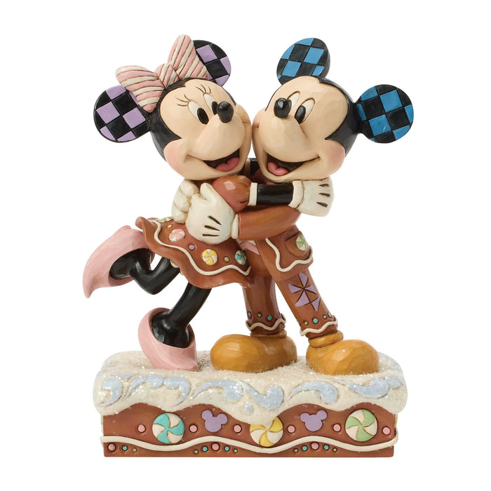 Statue of Mickey and Minnie Mouse hugging on a white background