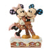Statue of Mickey and Minnie Mouse hugging on a white background