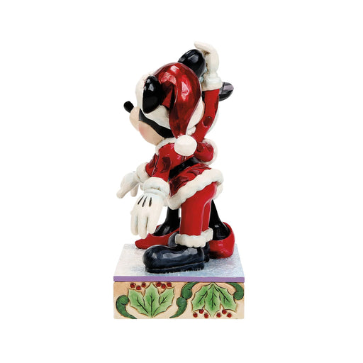 Animated character figurine in a red outfit with white accents on a decorative base.