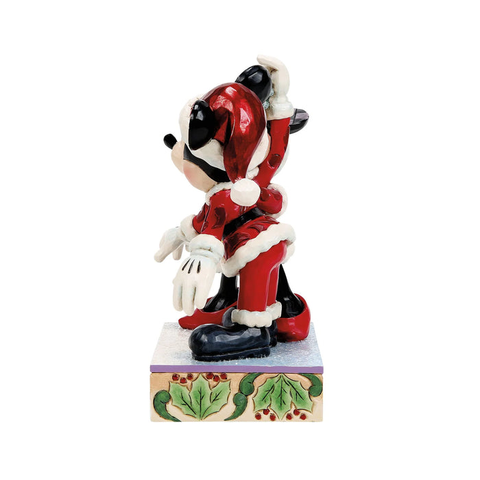 Animated character figurine in a red outfit with white accents on a decorative base.