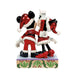 Two cartoon characters in festive outfits on a decorative base with holly design.