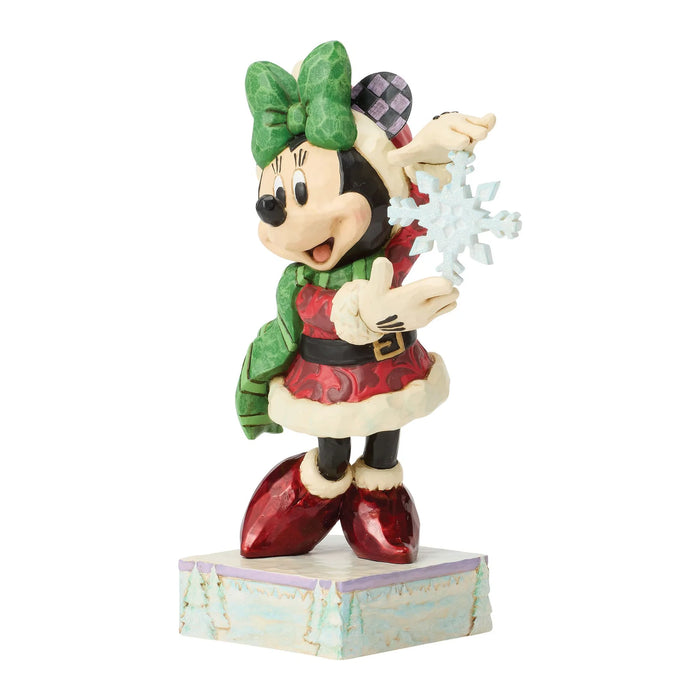 Minnie Mouse figurine in festive outfit with green bow and red shoes on a white background