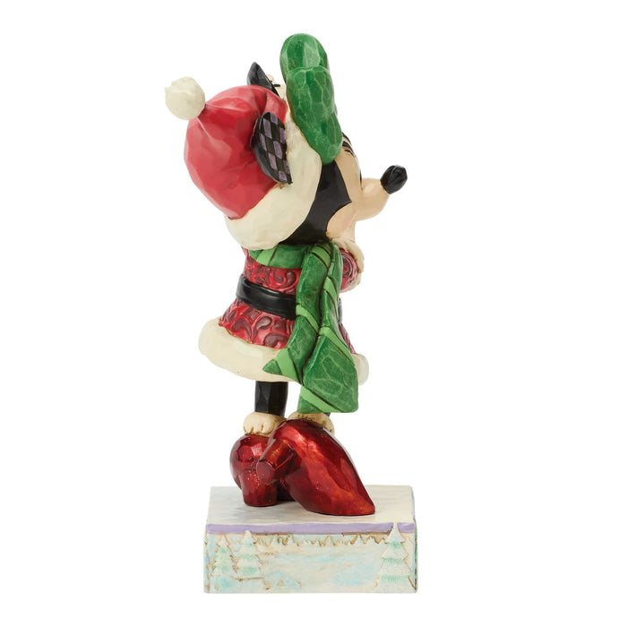 Animated character figurine with a red hat and green cape on a white background
