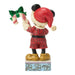 Figurine of a character in a red outfit with a candy cane and green bow on a white background