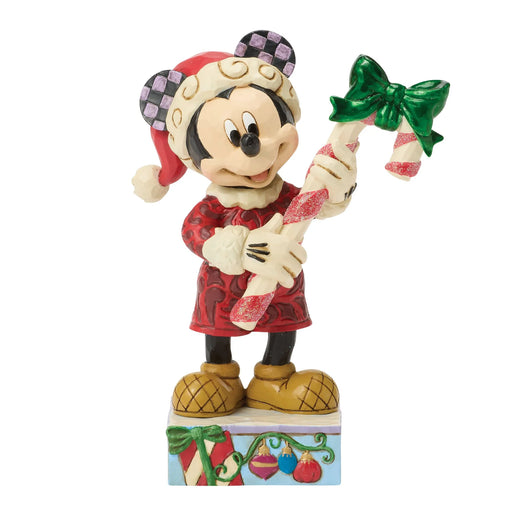 Christmas-themed figurine of a character holding candy canes on a white background