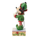 Animated character figurine in green and red outfit on a white background