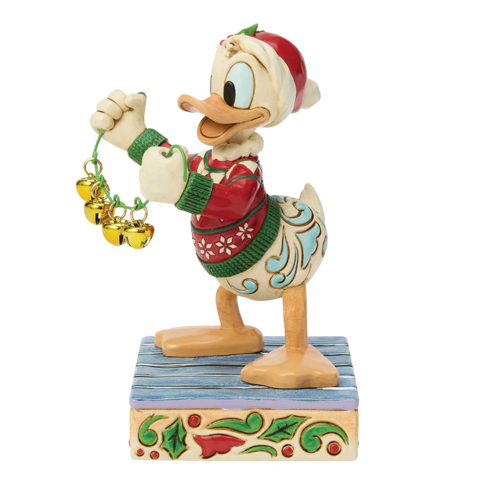Christmas-themed figurine of a cartoon character holding bells on a white background