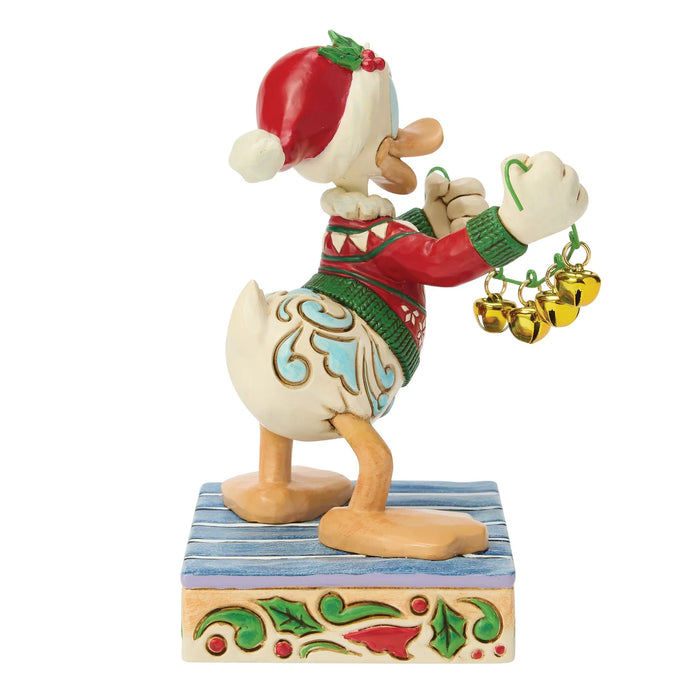 Christmas-themed figurine of a cartoon character with a red hat and green sweater on a white background