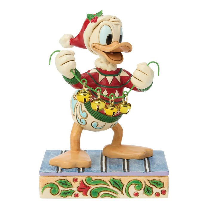 Animated character figurine wearing a Christmas hat and sweater with bells, on a white background.