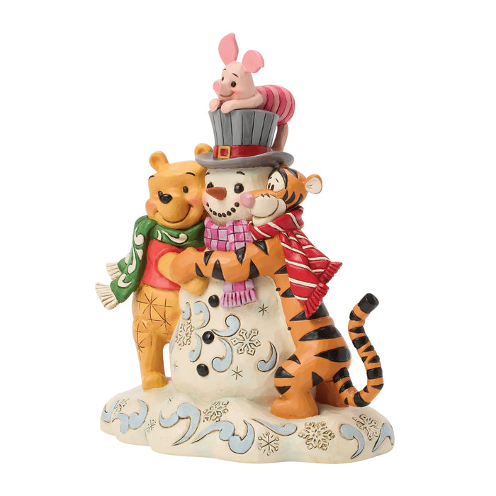 Figurine of Winnie the Pooh, Piglet, and Tiger with a snowman on a white background