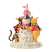 Figurine of Winnie the Pooh, Piglet, and Tigger on a white background