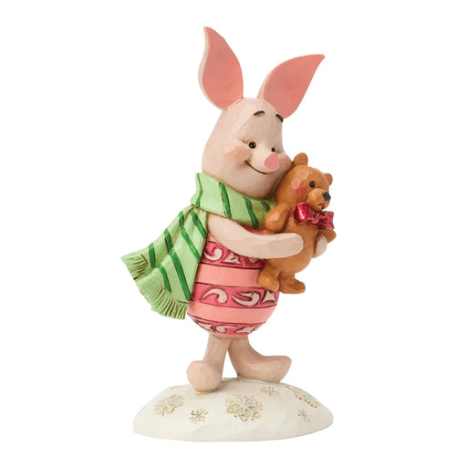 Figurine of a piglet holding a teddy bear on a white background