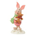 Figurine of a piglet holding a teddy bear on a white background