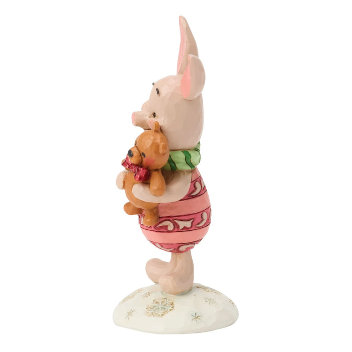 Figurine of a cartoon pig character holding a teddy bear on a white background