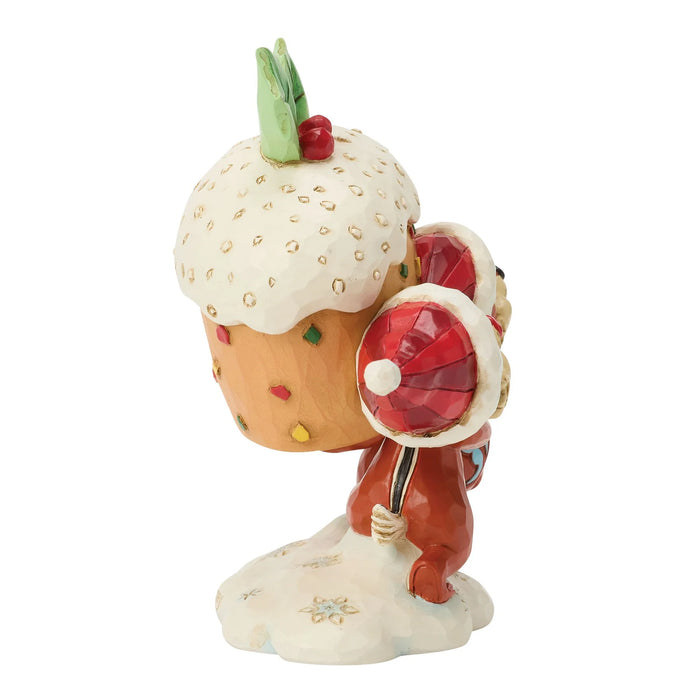Decorative figurine of a cupcake with a Santa Claus holding a lollipop on a white background