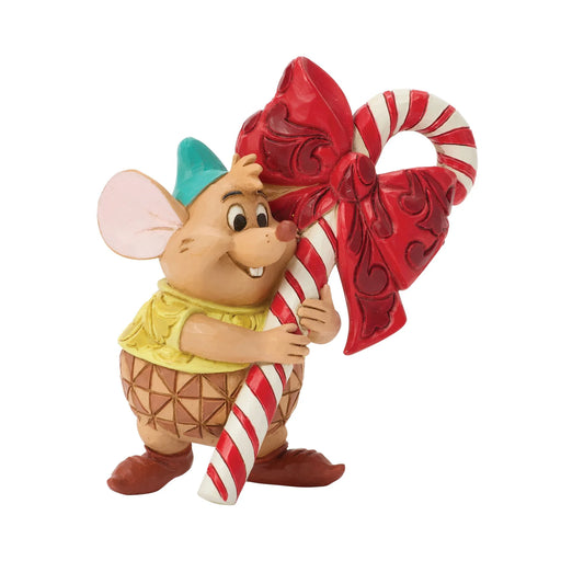 Animated character figurine holding a candy cane with a red bow on a white background
