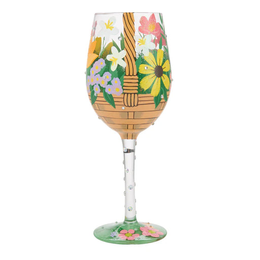 Decorative wine glass with floral and basket design on a white background