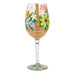 Decorative wine glass with floral and basket design on a white background