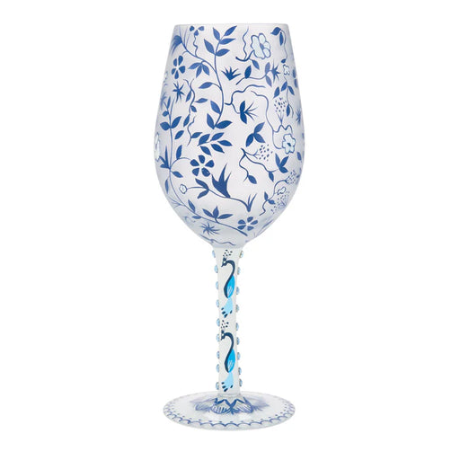 Decorative wine glass with blue floral patterns on a white background