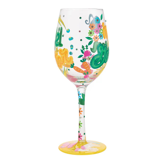 Decorative wine glass with colorful designs on a white background
