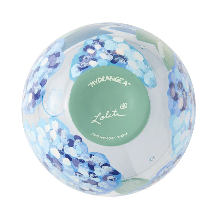 Round container with floral design and 'Lolita' branding on a white background