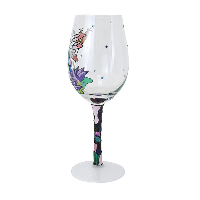 Decorative wine glass with colorful floral design on a white background