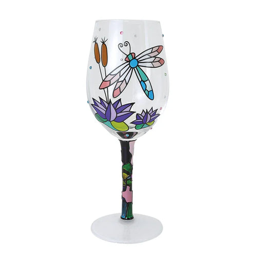 Decorative wine glass with a dragonfly and floral design on a white background