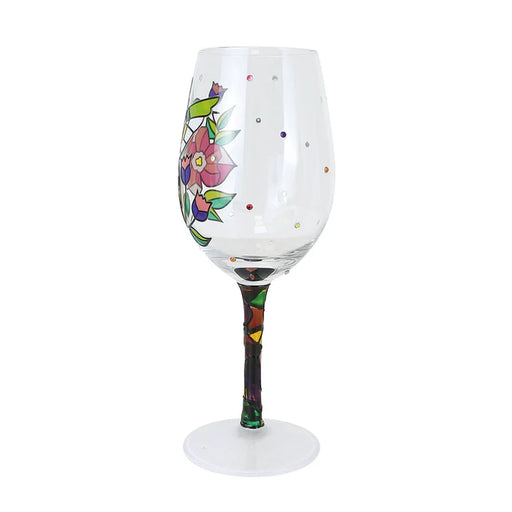 Decorative wine glass with floral design on a white background