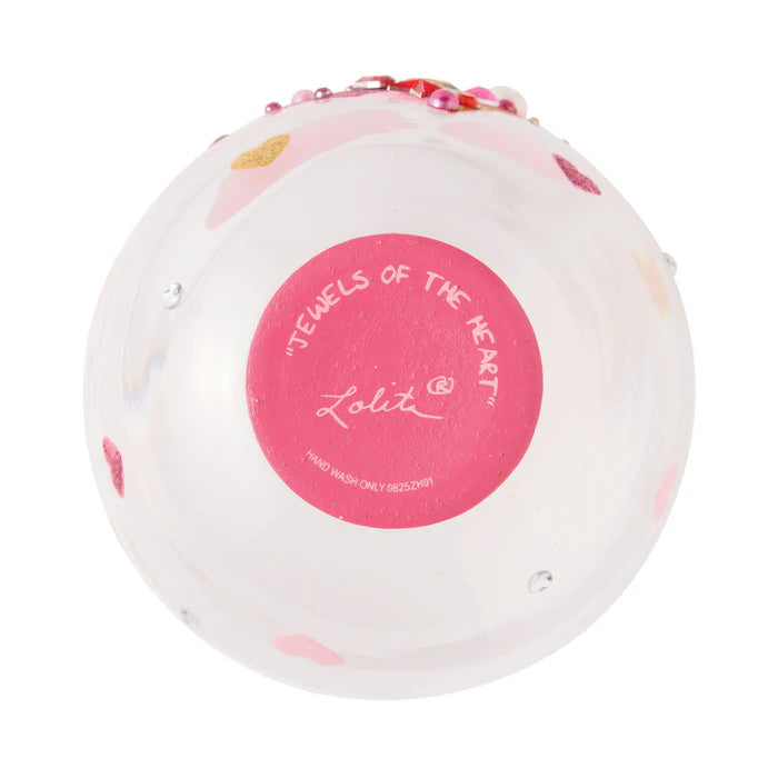 Round bath bomb with floral design and 'Lolita' branding on a white background