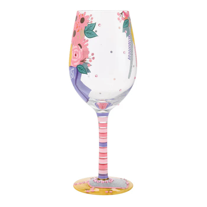 Decorative wine glass with floral design on a white background