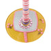 Decorative item with pink and purple striped pole on a yellow base with pink flowers and embellishments.