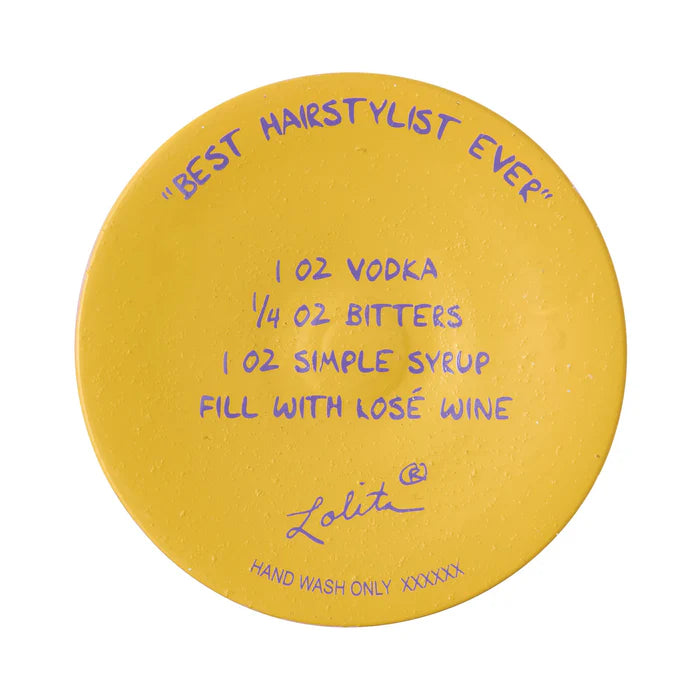 Round yellow coaster with purple text and branding on a white background