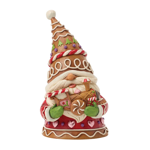Gingerbread gnome figurine holding a gingerbread train