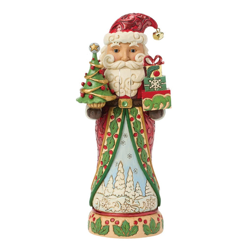 Festive Santa nutcracker figurine holding a Christmas tree and gifts on a white background