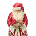 Festive Santa figurine holding a nest of cardinals on a white background