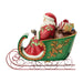 Decorative figurine of Santa Claus in a green sleigh with gifts on a white background
