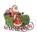 Figurine of Santa in a decorative sleigh with bags of gifts on a white background