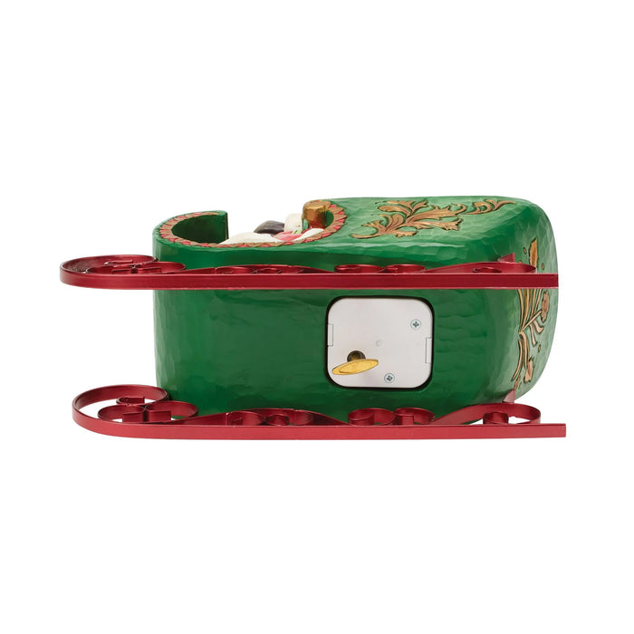 Green sleigh figure with a wind up attached